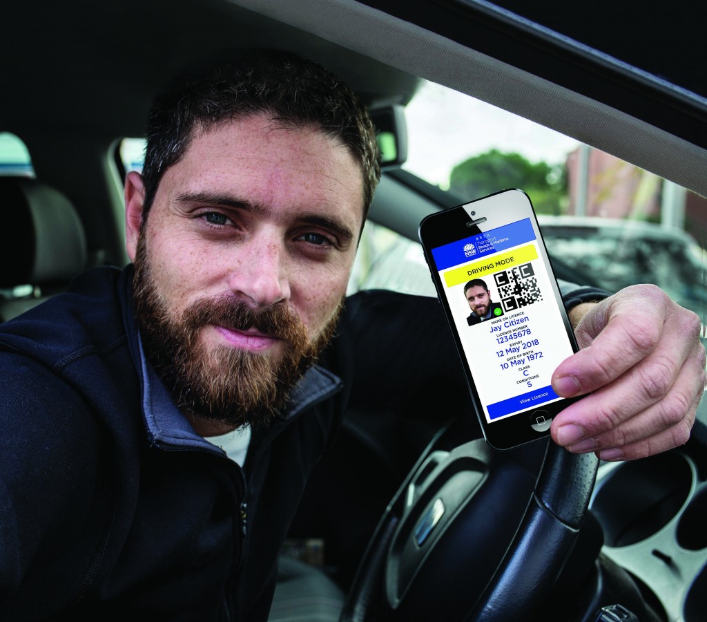 Happy man in his car shows french driver licence